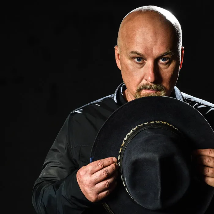 Nick Phoenix of Two Steps From Hell - portrait holding a black hat